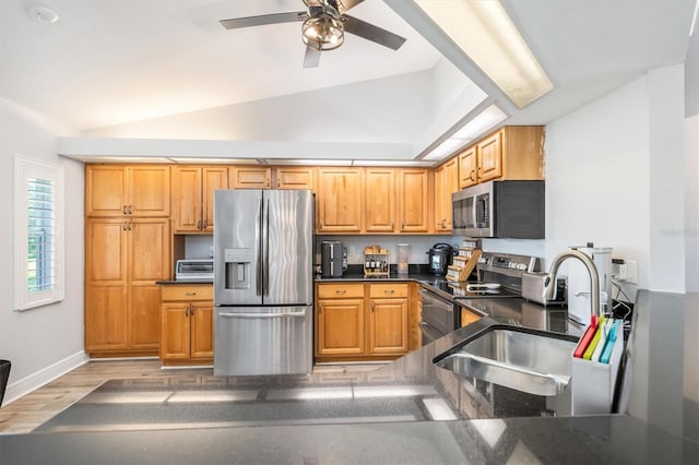 198 Porto Velho St, Punta Gorda, FL 33983 - kitchen with appliances with stainless steel finishes, vaulted ceiling, a ceiling fan, and light wood-style floors