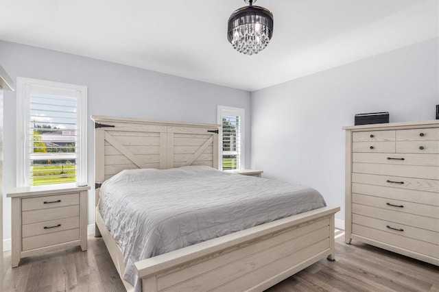 198 Porto Velho St, Punta Gorda, FL 33983 - bedroom featuring wood finished floors and a chandelier