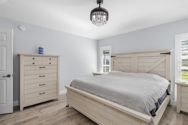 198 Porto Velho St, Punta Gorda, FL 33983 - bedroom featuring light wood-style flooring and a chandelier