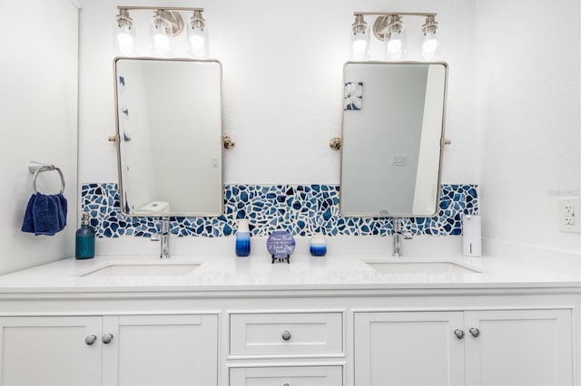 198 Porto Velho St, Punta Gorda, FL 33983 - bathroom featuring double vanity and decorative backsplash