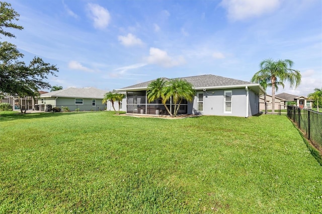 198 Porto Velho St, Punta Gorda, FL 33983 - back of house with a sunroom, a fenced backyard, stucco siding, and roof with shingles