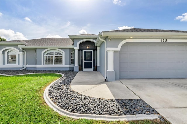198 Porto Velho St, Punta Gorda, FL 33983 - ranch-style home with stucco siding, a garage, driveway, and a front lawn