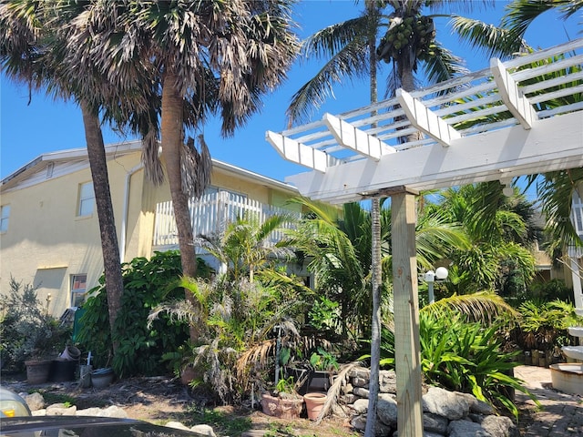 686 S Atlantic Ave Unit 1-8, Cocoa Beach, FL 32931 - view of side of property featuring a pergola and stucco siding