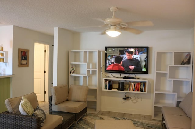 686 S Atlantic Ave Unit 1-8, Cocoa Beach, FL 32931 - living room featuring ceiling fan, wood finished floors, and a textured ceiling