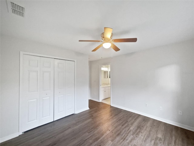 4615 River Overlook Dr, Valrico, FL 33596 - unfurnished bedroom with dark wood-style flooring, a closet, ceiling fan, and ensuite bath