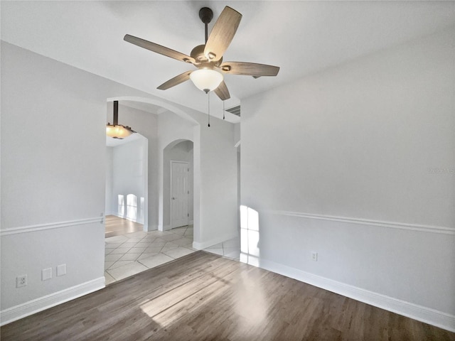 4615 River Overlook Dr, Valrico, FL 33596 - spare room with arched walkways, a ceiling fan, and wood finished floors