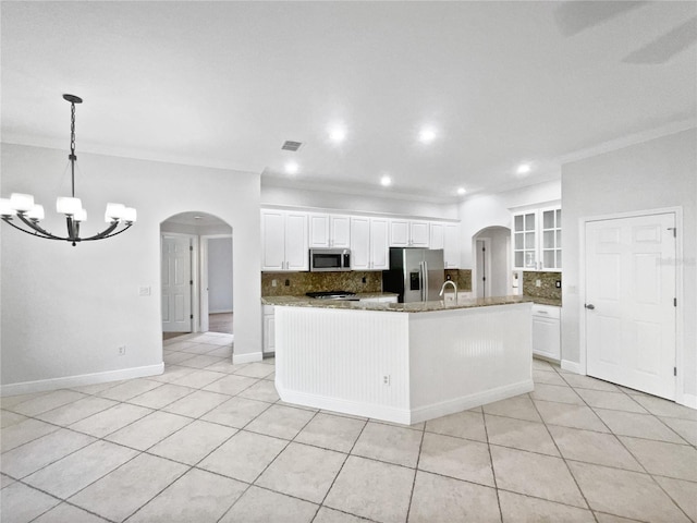 4615 River Overlook Dr, Valrico, FL 33596 - kitchen with appliances with stainless steel finishes, arched walkways, tasteful backsplash, a chandelier, and recessed lighting