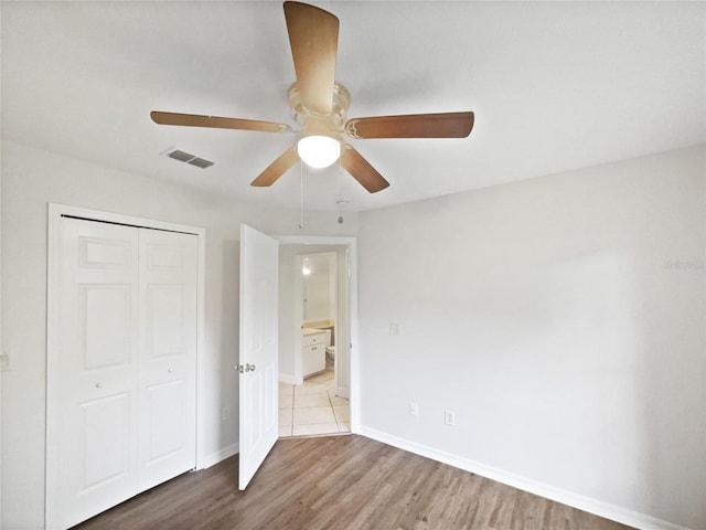 4615 River Overlook Dr, Valrico, FL 33596 - unfurnished bedroom featuring a closet, wood finished floors, and a ceiling fan