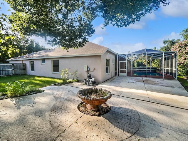 4615 River Overlook Dr, Valrico, FL 33596 - rear view of property featuring a patio, stucco siding, a pool, and glass enclosure