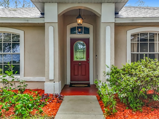 16634 Pine Timber Ave, Montverde, FL 34756 - entrance to property featuring a shingled roof and stucco siding