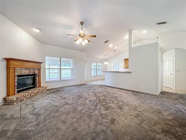 16634 Pine Timber Ave, Montverde, FL 34756 - unfurnished living room with lofted ceiling, carpet floors, ceiling fan, a fireplace, and arched walkways