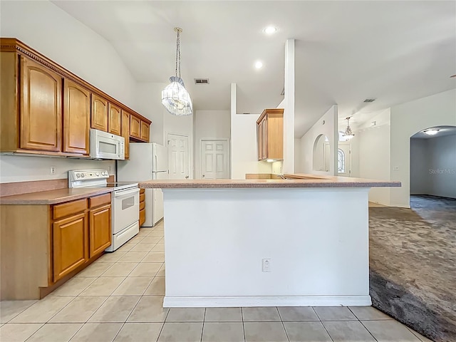 16634 Pine Timber Ave, Montverde, FL 34756 - kitchen featuring white appliances, arched walkways, vaulted ceiling, light tile patterned floors, and pendant lighting
