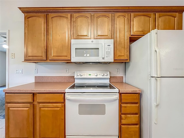 16634 Pine Timber Ave, Montverde, FL 34756 - kitchen featuring white appliances, brown cabinetry, and light countertops