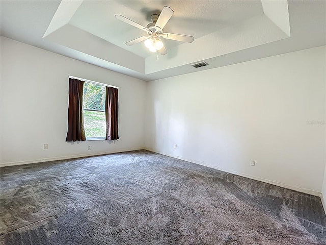 16634 Pine Timber Ave, Montverde, FL 34756 - carpeted empty room featuring a tray ceiling and a ceiling fan