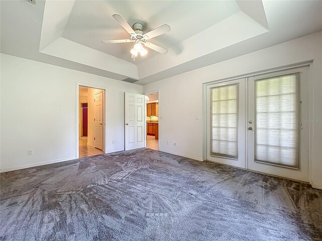 16634 Pine Timber Ave, Montverde, FL 34756 - unfurnished bedroom with a tray ceiling, french doors, carpet, access to exterior, and ceiling fan