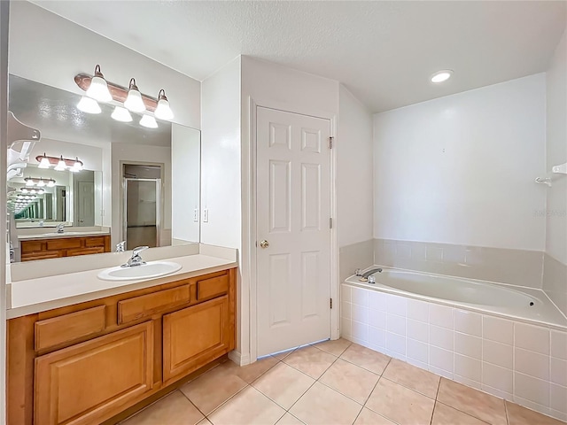 16634 Pine Timber Ave, Montverde, FL 34756 - bathroom featuring vanity, a garden tub, tile patterned floors, and a shower with door