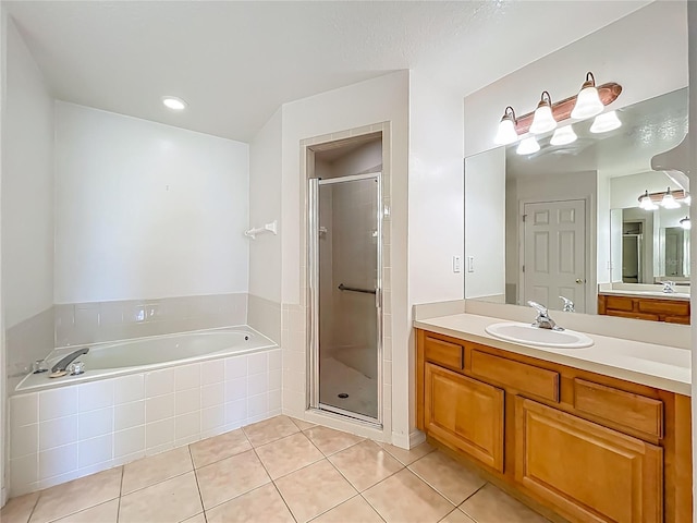 16634 Pine Timber Ave, Montverde, FL 34756 - full bathroom featuring vanity, a bath, tile patterned flooring, and a stall shower