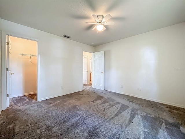 16634 Pine Timber Ave, Montverde, FL 34756 - unfurnished bedroom with carpet floors, a spacious closet, and ceiling fan
