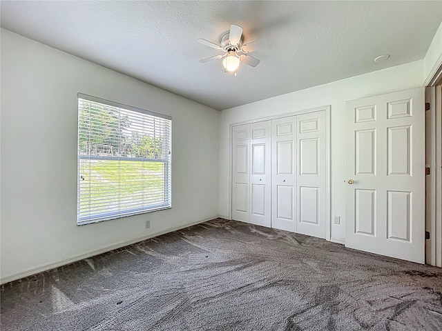 16634 Pine Timber Ave, Montverde, FL 34756 - unfurnished bedroom featuring carpet flooring, a closet, a ceiling fan, and a textured ceiling