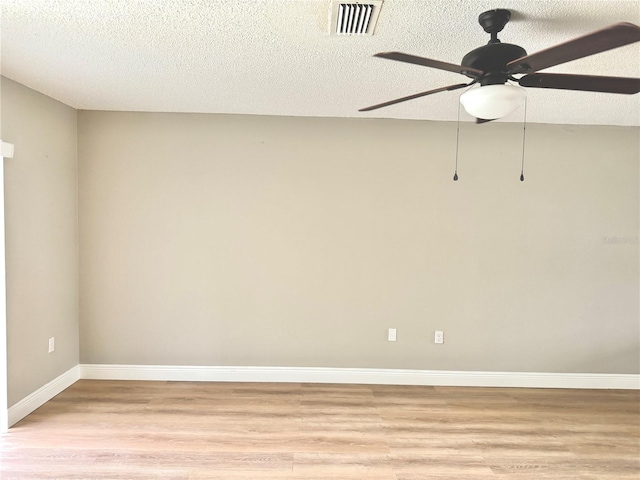 6054 Amberly Ct Unit T21, Orlando, FL 32822 - spare room with light wood-style floors, ceiling fan, and a textured ceiling