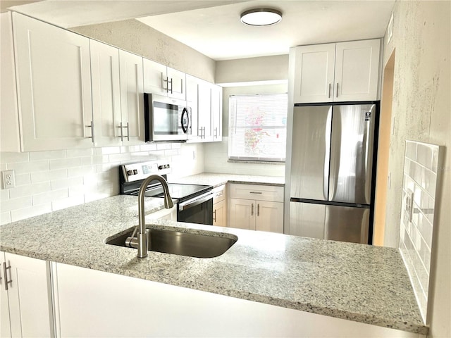 6054 Amberly Ct Unit T21, Orlando, FL 32822 - kitchen featuring appliances with stainless steel finishes, tasteful backsplash, and light stone counters