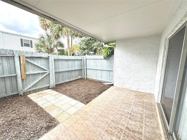 6054 Amberly Ct Unit T21, Orlando, FL 32822 - view of patio / terrace featuring a gate