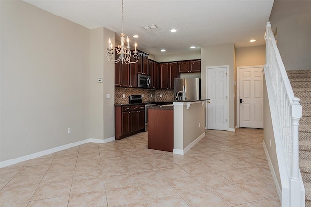 5072 Cypress Branch Pt, Oviedo, FL 32765 - kitchen with appliances with stainless steel finishes, dark countertops, a chandelier, decorative backsplash, and light tile patterned floors