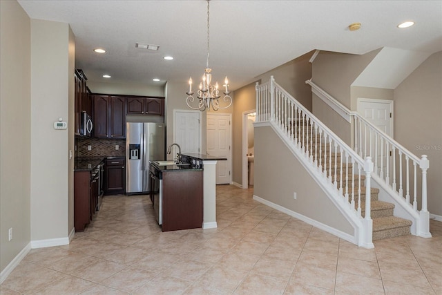5072 Cypress Branch Pt, Oviedo, FL 32765 - kitchen featuring dark countertops, appliances with stainless steel finishes, tasteful backsplash, a chandelier, and dark brown cabinets