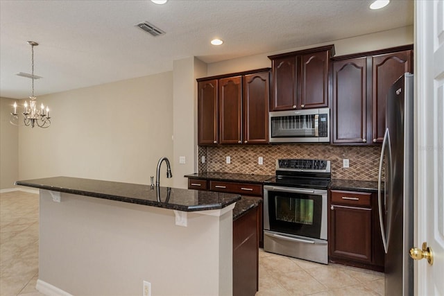 5072 Cypress Branch Pt, Oviedo, FL 32765 - kitchen featuring appliances with stainless steel finishes, light tile patterned flooring, decorative backsplash, a chandelier, and recessed lighting