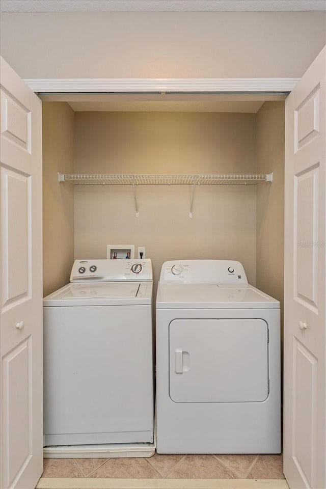 5072 Cypress Branch Pt, Oviedo, FL 32765 - washroom with washer and clothes dryer and light tile patterned floors