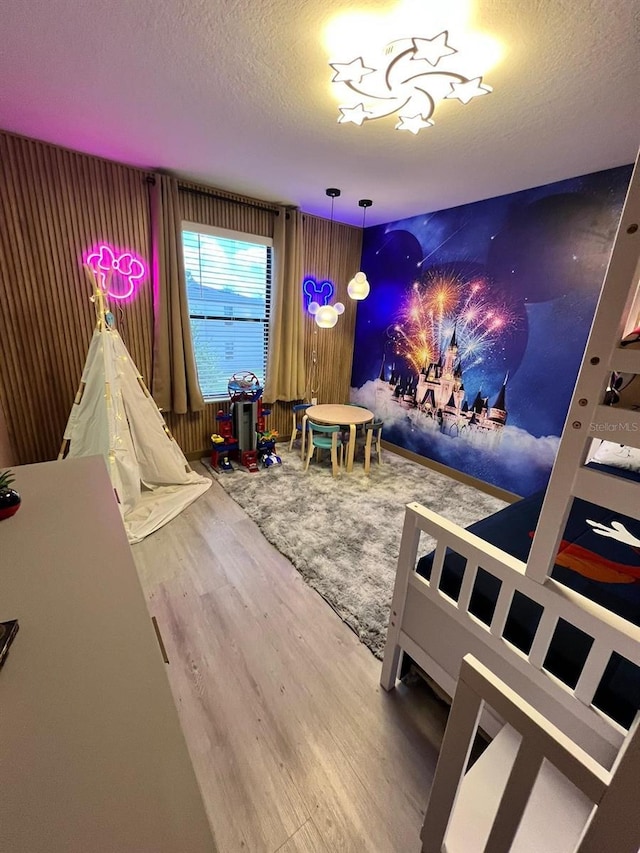 3292 Tranquil Trl, Kissimmee, FL 34747 - rec room with wood finished floors and a textured ceiling