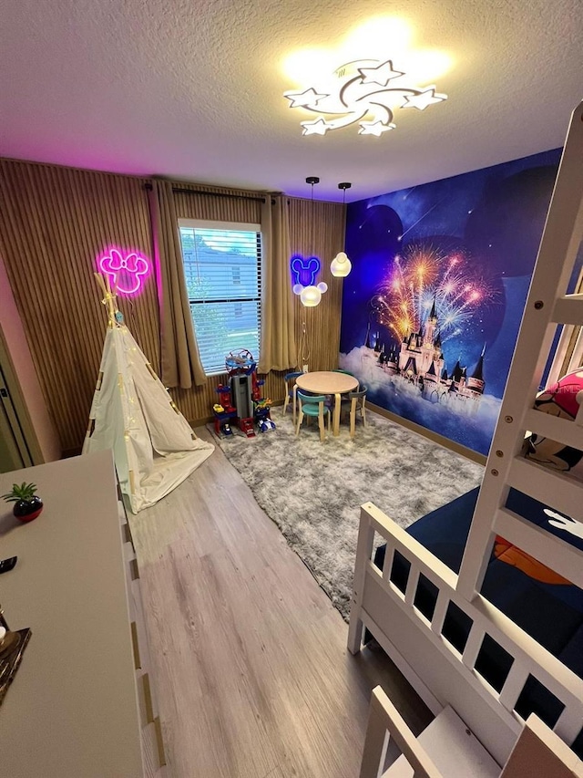 3292 Tranquil Trl, Kissimmee, FL 34747 - playroom featuring wood finished floors and a textured ceiling