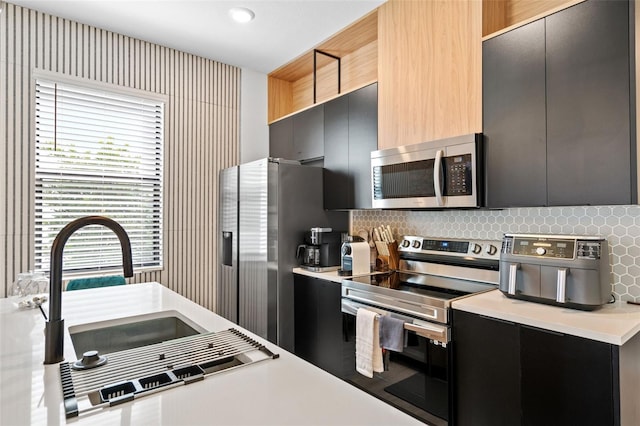 3292 Tranquil Trl, Kissimmee, FL 34747 - kitchen featuring appliances with stainless steel finishes, modern cabinets, dark cabinets, and light countertops
