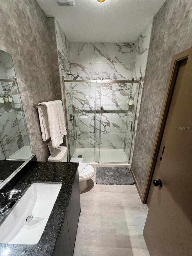 3292 Tranquil Trl, Kissimmee, FL 34747 - bathroom featuring vanity, a marble finish shower, and wood finished floors