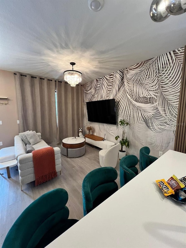 3292 Tranquil Trl, Kissimmee, FL 34747 - living room with wood finished floors, a chandelier, and wallpapered walls
