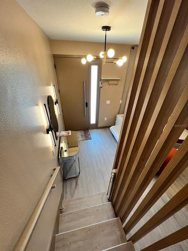 3292 Tranquil Trl, Kissimmee, FL 34747 - staircase featuring wood finished floors, a textured wall, and a textured ceiling
