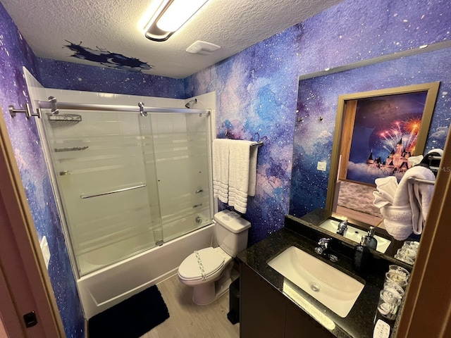 3292 Tranquil Trl, Kissimmee, FL 34747 - bathroom featuring a textured ceiling, enclosed tub / shower combo, vanity, wallpapered walls, and wood finished floors