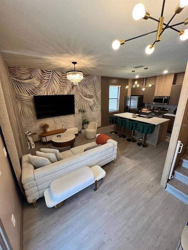 3292 Tranquil Trl, Kissimmee, FL 34747 - living area featuring a chandelier and light wood finished floors