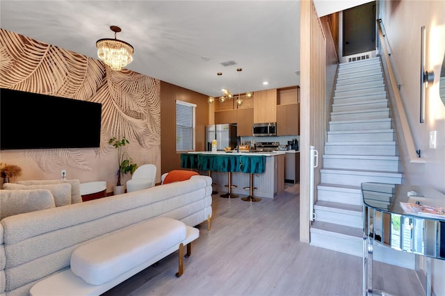 3292 Tranquil Trl, Kissimmee, FL 34747 - living area featuring a chandelier, light wood finished floors, stairway, and recessed lighting