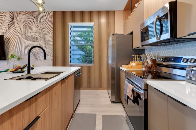 3292 Tranquil Trl, Kissimmee, FL 34747 - kitchen with stainless steel appliances, light countertops, light wood finished floors, and decorative backsplash