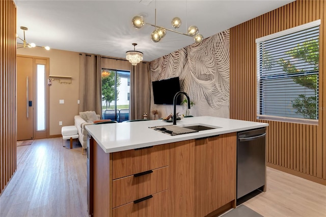 3292 Tranquil Trl, Kissimmee, FL 34747 - kitchen with stainless steel dishwasher, light wood finished floors, a chandelier, and wallpapered walls