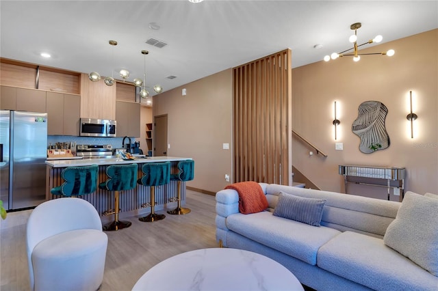 3292 Tranquil Trl, Kissimmee, FL 34747 - living room featuring light wood-style floors and stairs