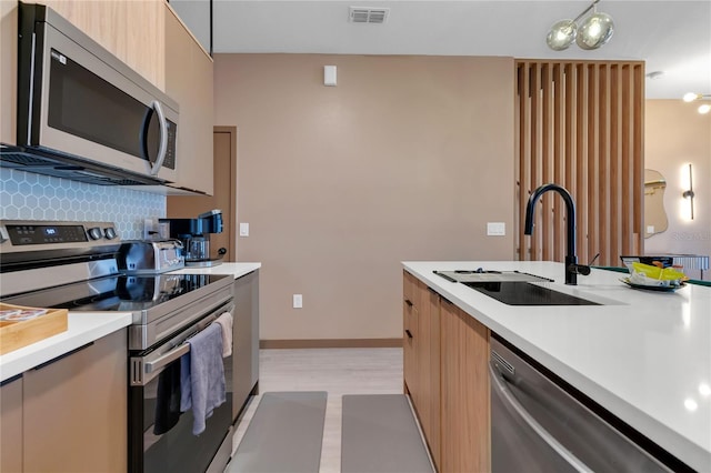 3292 Tranquil Trl, Kissimmee, FL 34747 - kitchen with stainless steel appliances, modern cabinets, light countertops, and decorative backsplash