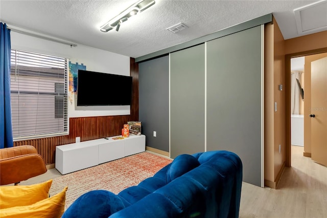 3292 Tranquil Trl, Kissimmee, FL 34747 - cinema room featuring wood finished floors, a textured ceiling, and wood walls