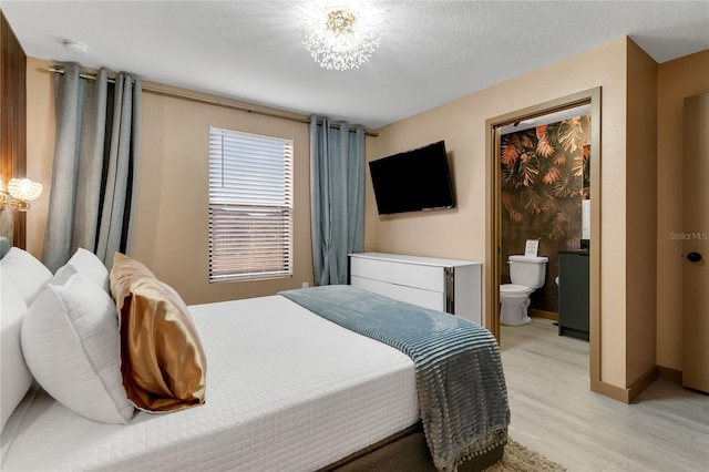 3292 Tranquil Trl, Kissimmee, FL 34747 - bedroom featuring light wood-type flooring and a chandelier