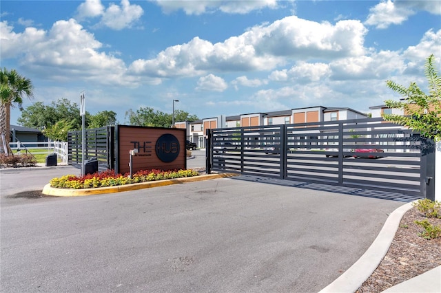 3292 Tranquil Trl, Kissimmee, FL 34747 - view of asphalt street featuring a gate, street lighting, and a gated entry