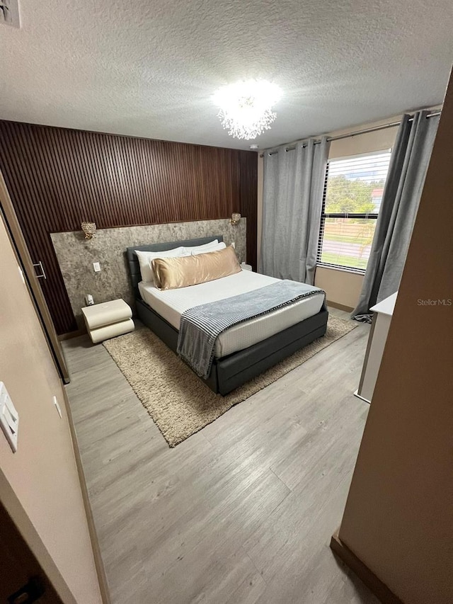 3292 Tranquil Trl, Kissimmee, FL 34747 - bedroom featuring wood finished floors and a textured ceiling