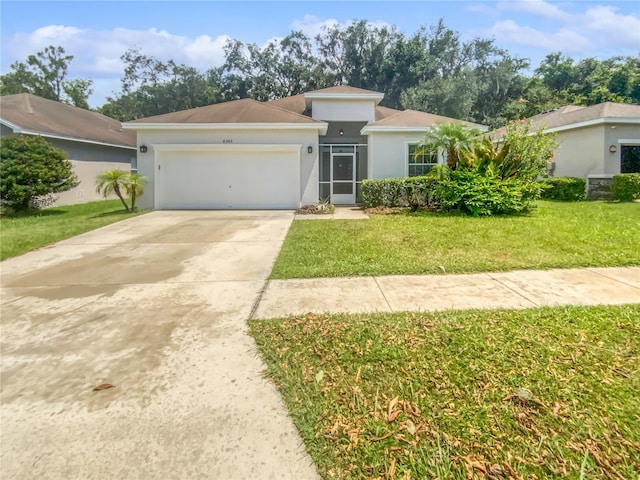 6303 Twin Bridges Dr, Zephyrhills, FL 33541 - view of front of house with concrete driveway, an attached garage, a front yard, and stucco siding