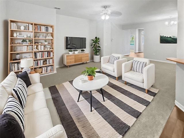 6303 Twin Bridges Dr, Zephyrhills, FL 33541 - carpeted living area with a ceiling fan and a chandelier