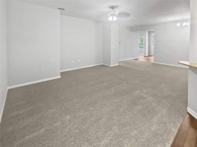 6303 Twin Bridges Dr, Zephyrhills, FL 33541 - empty room featuring ceiling fan, a chandelier, and carpet floors
